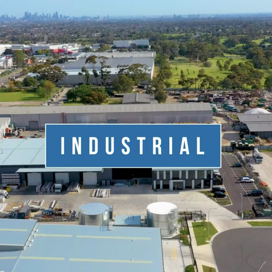 An industrial warehouse stands tall against the sky, showcased in a construction video.